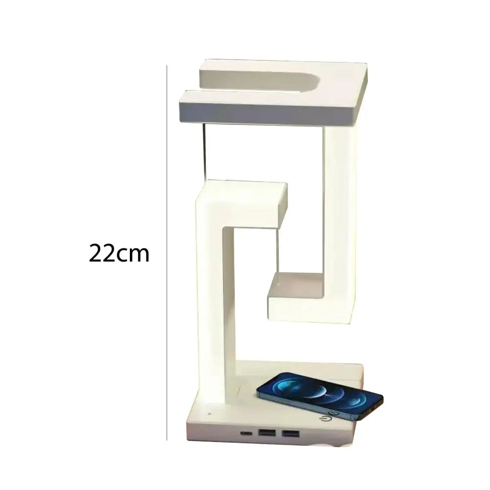 A sleek modern white wireless charger desk lamp with minimalist geometric design and integrated usb ports at the base