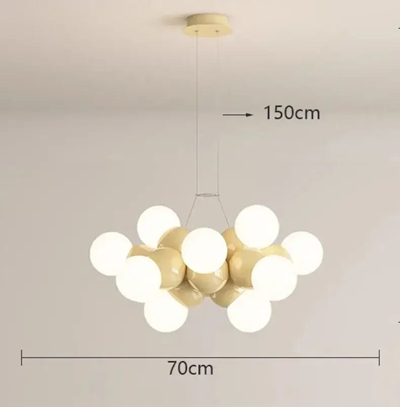Modern white glass globe pendant light fixture with glossy cream and white bulbs hanging from gold ceiling mount