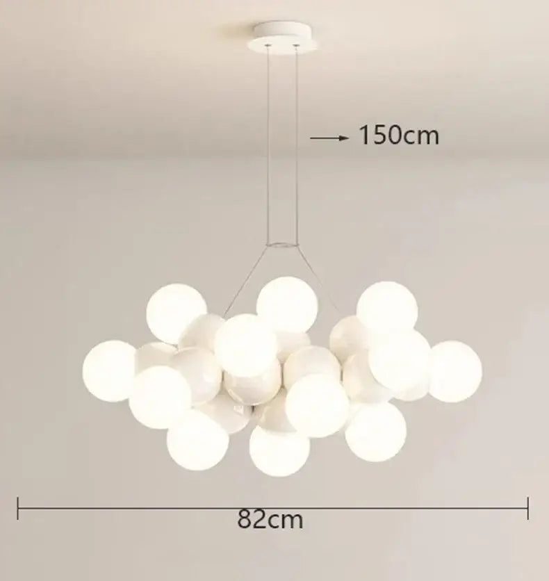 A modern white glass globe pendant light fixture with frosted globes hanging from a minimalist ceiling mount for dining rooms