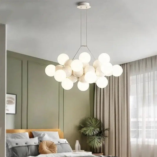 Modern white glass globe pendant light fixture with minimalist metal frame designed for dining room lighting