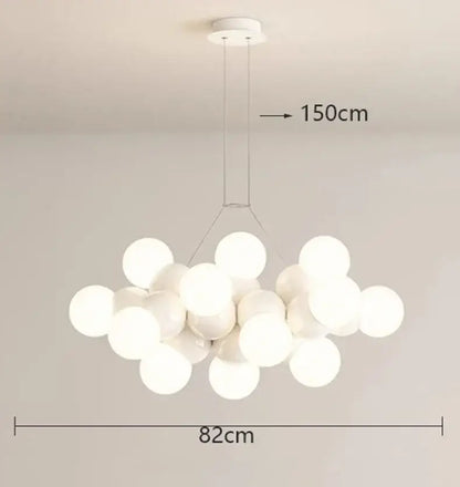 Modern white glass globe pendant light fixture with frosted globes suspended from minimalist ceiling mount