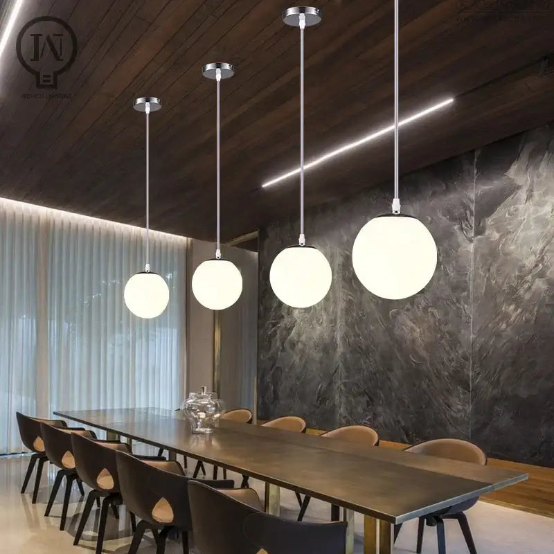 Modern pendant light with white globe shade and frosted glass fixtures for kitchen and dining room use