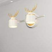 Modern white and gold antler wall light fixture with cylindrical shades designed for bathroom vanity natural light