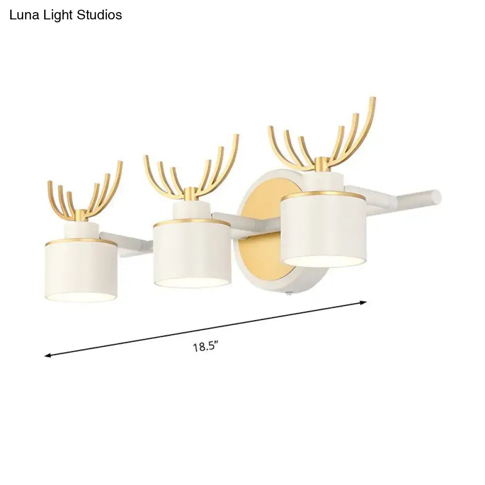 Modern white and gold antler wall light fixture with three cylindrical shades for bathroom vanity natural light