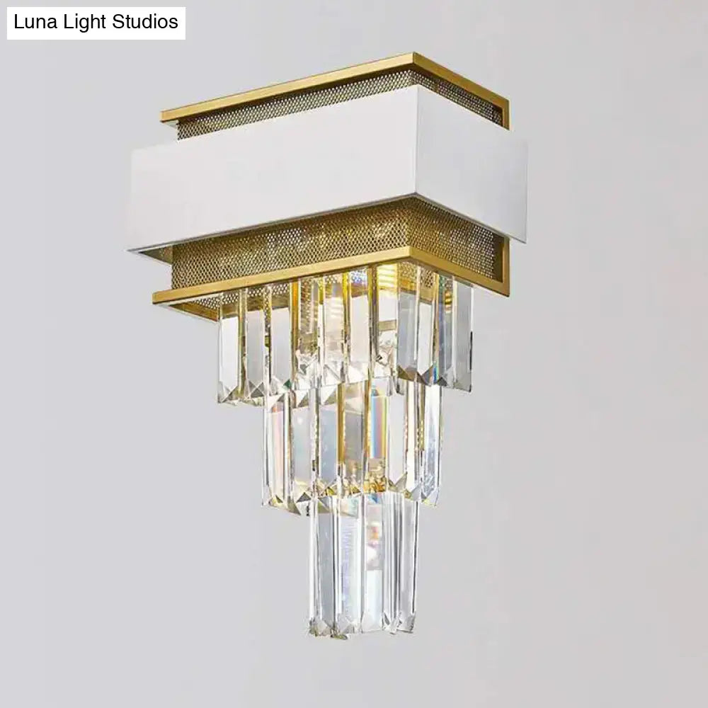 Modern wall lamp with a white and gold metallic frame and cascading clear crystal prisms wall sconce for bedroom