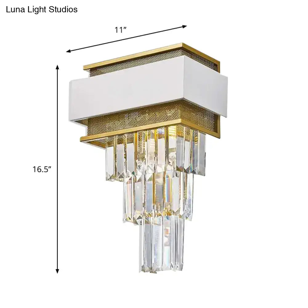 Modern white and gold wall sconce with cascading clear crystal prisms ideal as a bedroom wall lamp