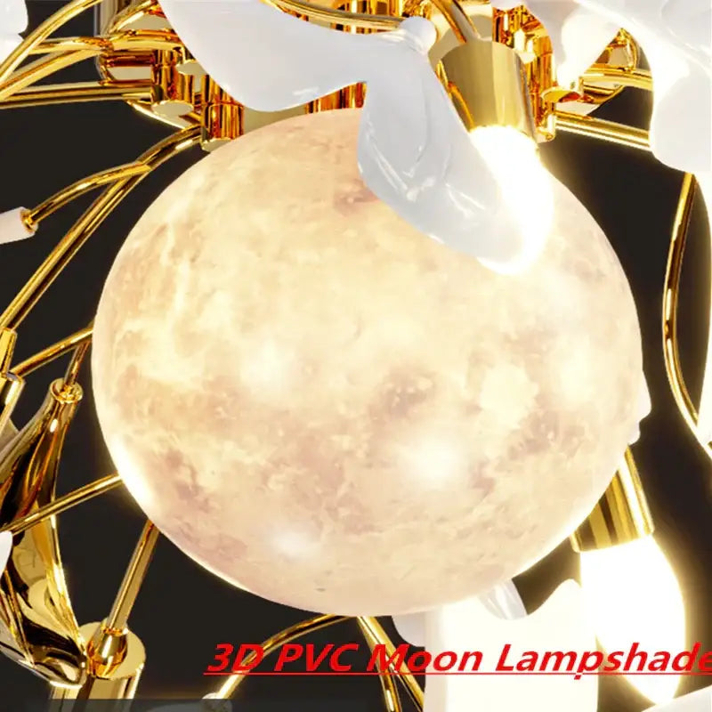 A luminous textured 3d pvc moon lampshade with warm glow complements the white and gold ginkgo leaf led ceiling chandelier