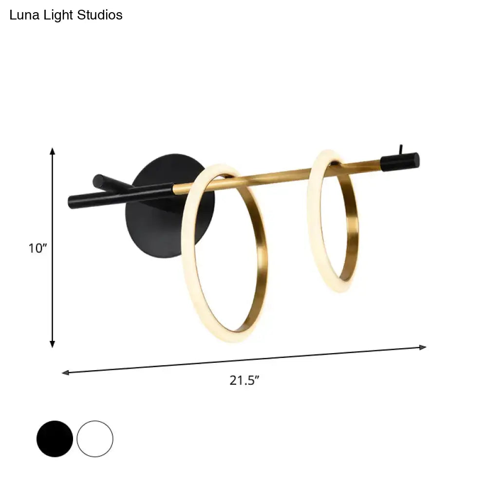 Modern white and gold ring light fixture wall light with sleek black base and two glowing gold rings minimalist design