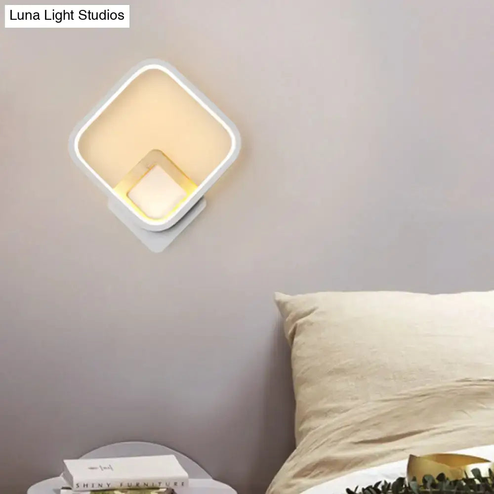 Modern white and gold wall sconce minimalist with warm white glowing light for a minimalist white bedroom