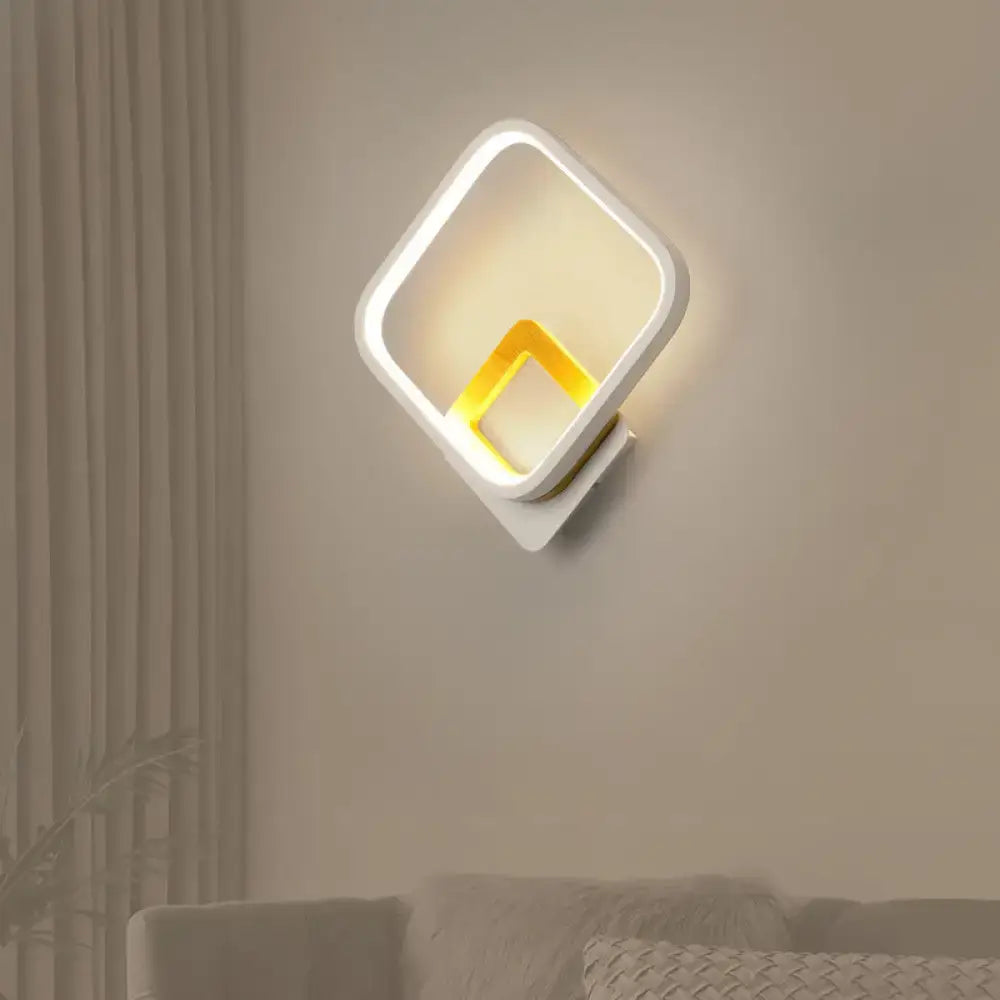 Modern white and gold wall sconce minimalist with a warm white glowing yellow inner frame for bedroom lighting