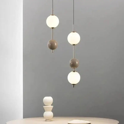 Modern white and gray glass pendant light with spherical shades and slender metal rods for dining room decorbites colorful ball led