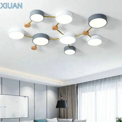 Modern white and gray wood ceiling chandelier with circular bulbs connected by gold metal arms for living room lighting