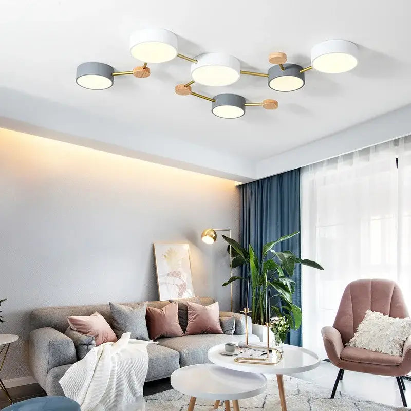 Modern white and gray wood ceiling chandelier with circular shades and gold-toned metal arms for living room lighting