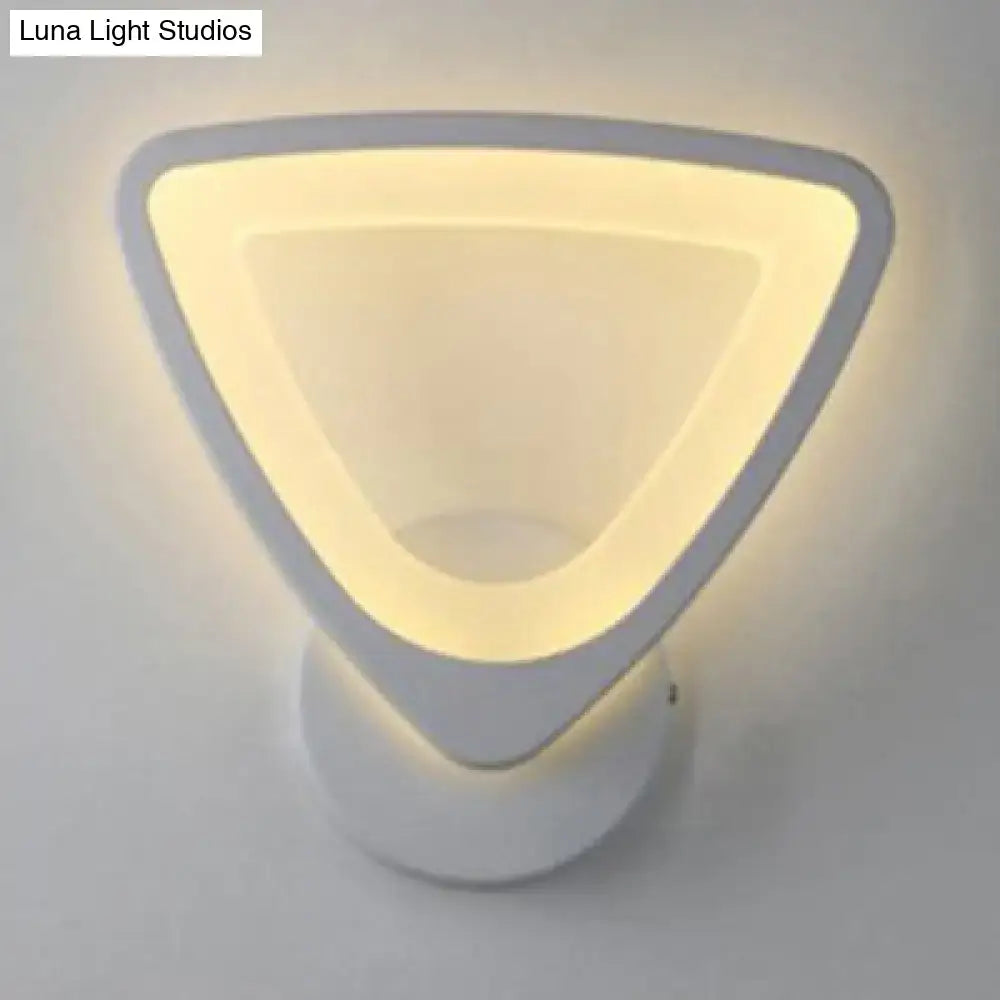 Modern white heart led wall sconce with minimalist triangular design and soft warm glow for bedroom lighting