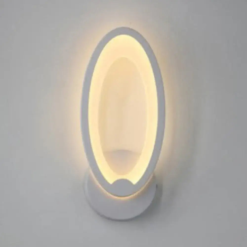Modern white heart led wall sconce with sleek oval shape and warm ambient lighting for minimalist bedroom use