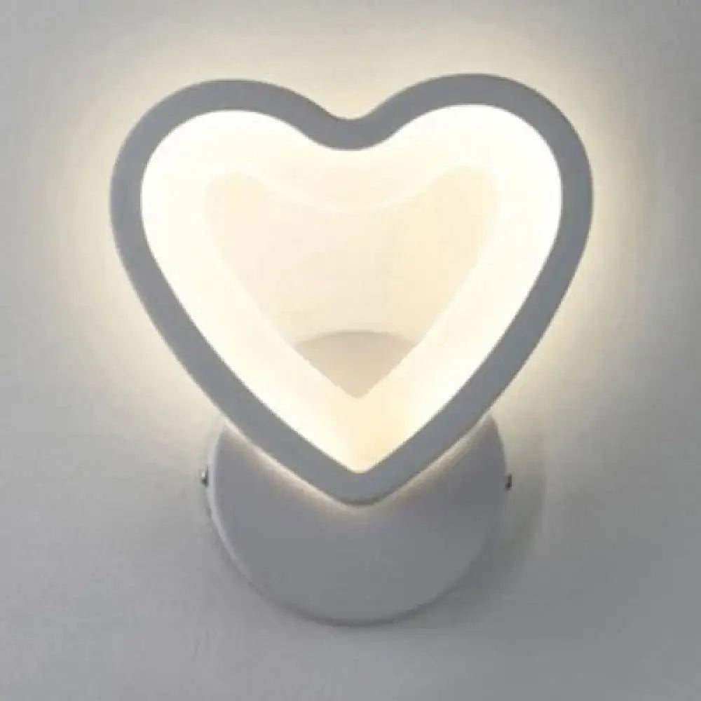Modern white heart led wall sconce with a sleek minimalist design for bedroom lighting mounted on the wall