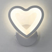 Modern white heart led wall sconce with a sleek minimalist design for bedroom lighting mounted on the wall