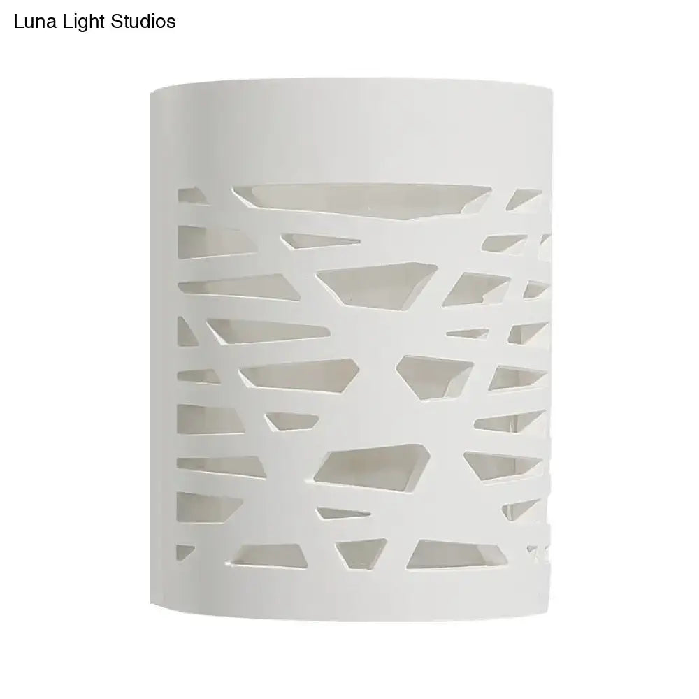 Modern white cylindrical wall sconce with geometric cutout pattern designed for bedroom led light bulb use