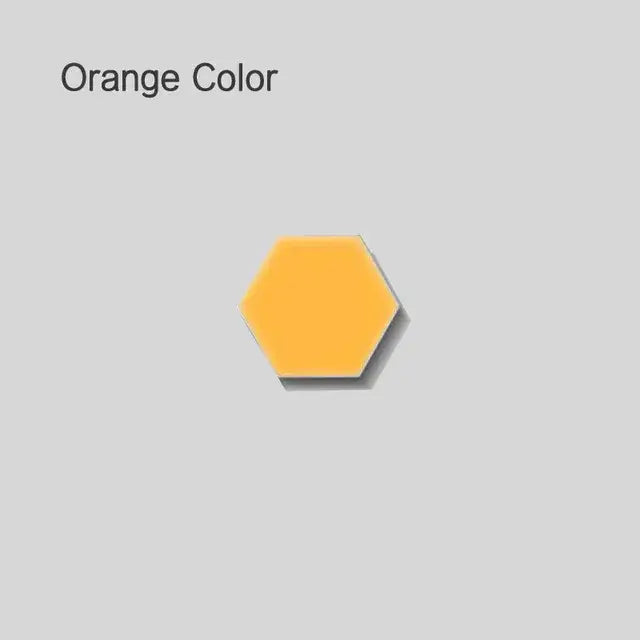 A solid orange hexagonal tile with a smooth glossy surface for modern white honeycomb modular quantum sconces led panel lights