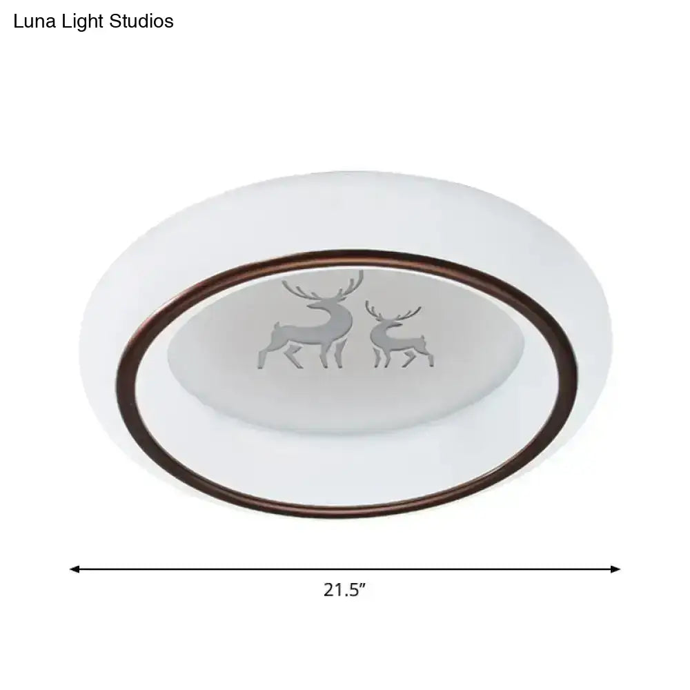 White oval LED ceiling light with bronze rim and frosted glass featuring etched deer and hot air balloon designs