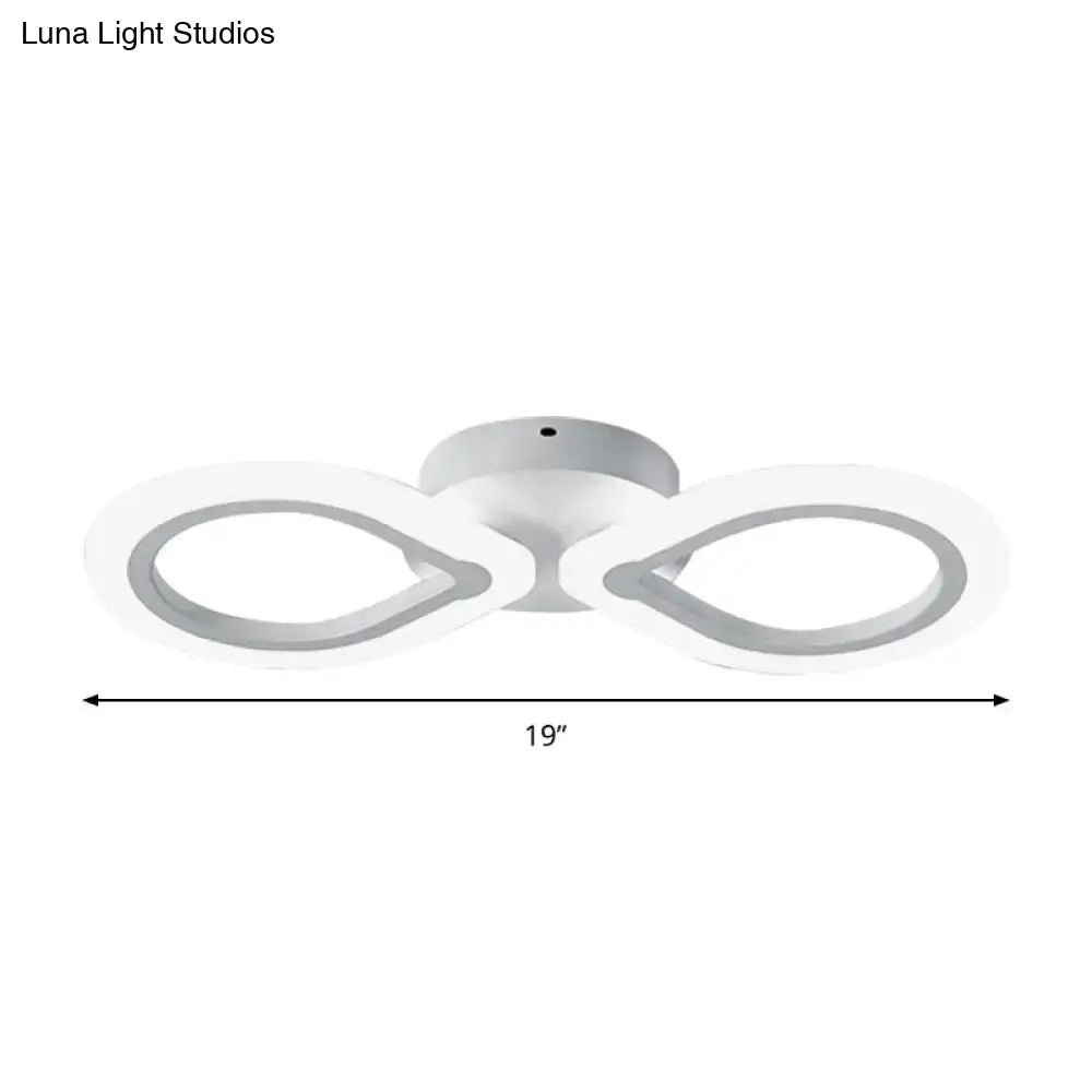 Modern white led wall light fixture with two infinity-looped rings featuring a simple design and adjustable fixture height