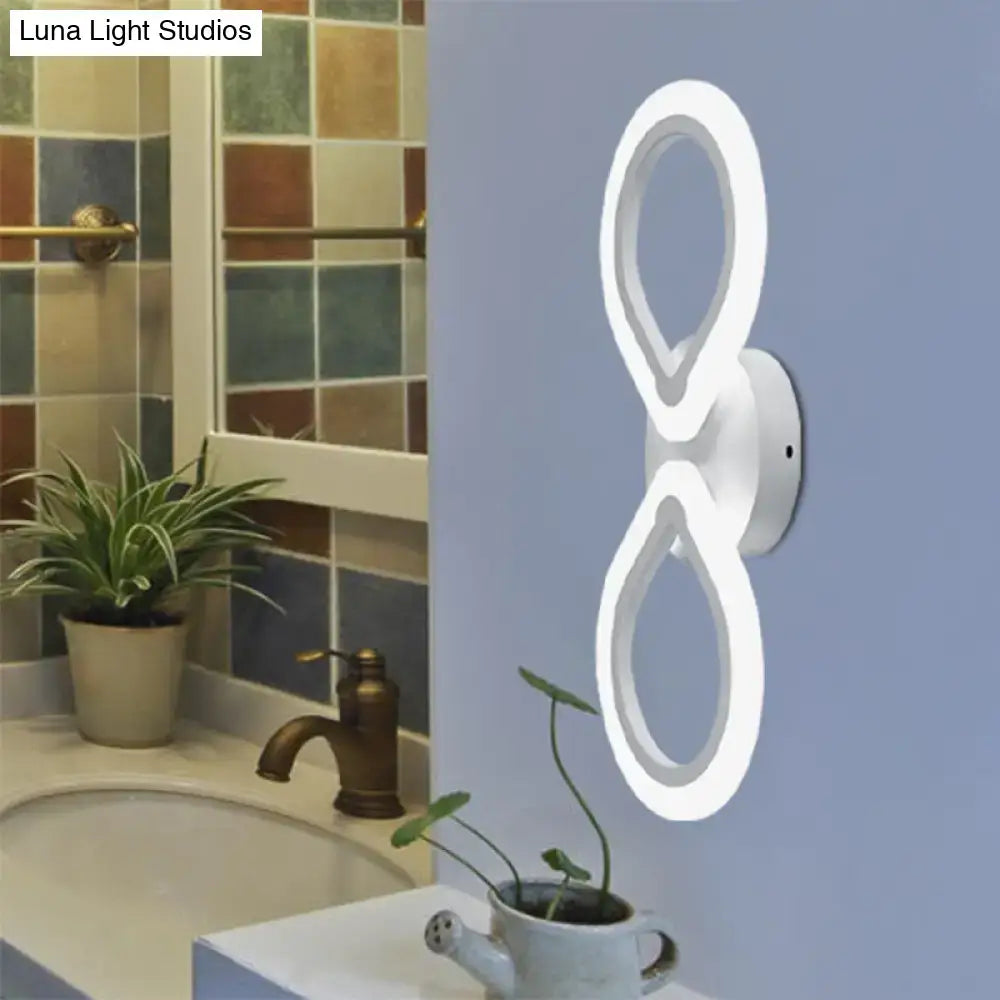 Modern white infinity-loop led wall light fixture with simple design and bulb base for bedroom use