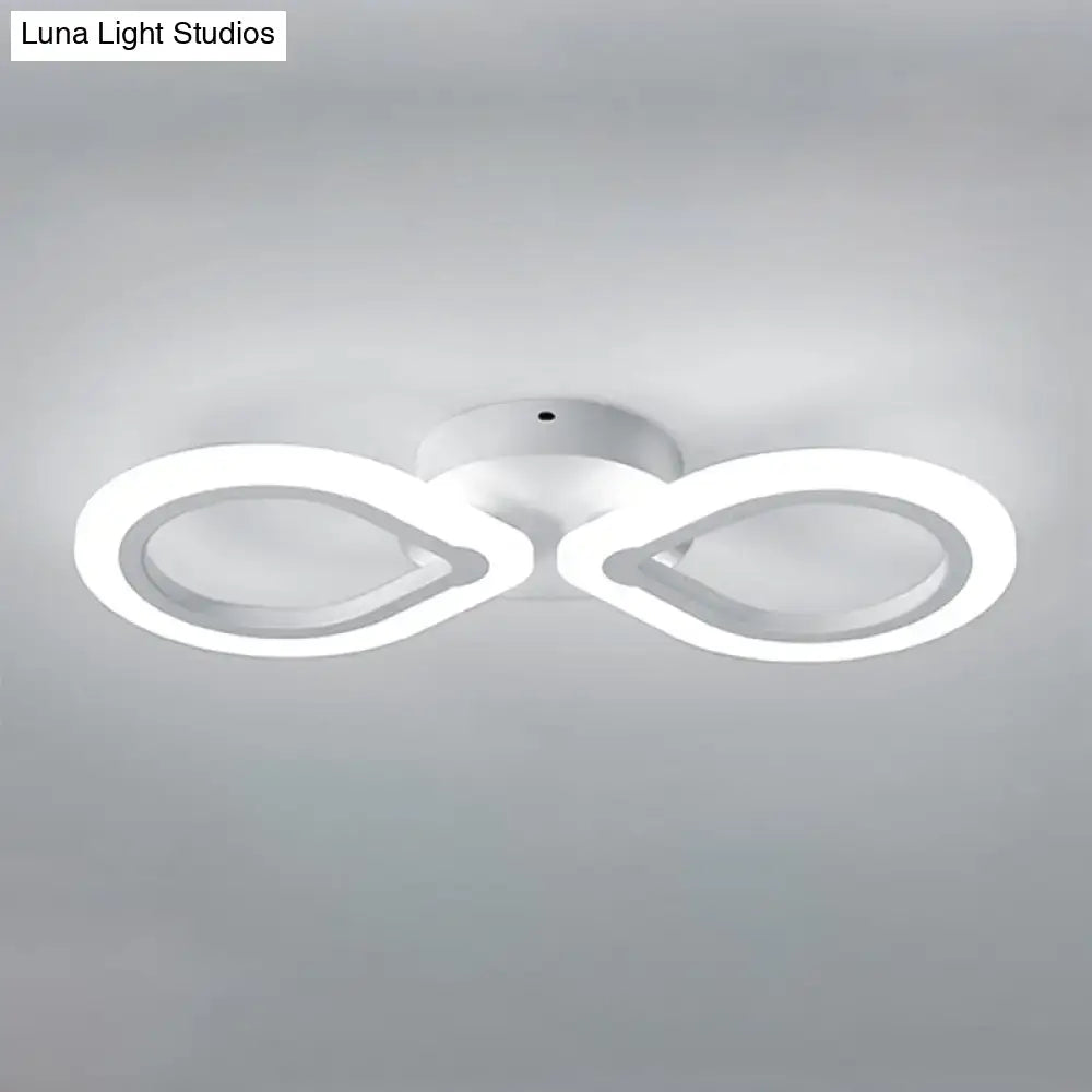 Modern white infinity-shaped led light fixture with simple design and bulb base for bedroom wall installation