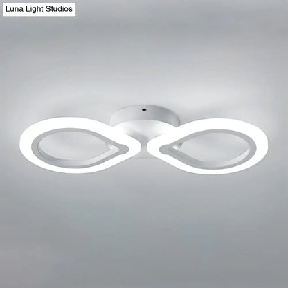 Modern white infinity-shaped led light fixture with simple design and bulb base for bedroom wall installation