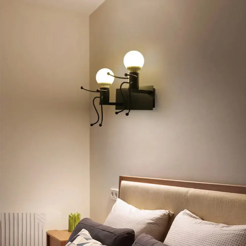Black metal wall sconce with two frosted glass bulbs designed as a modern white iron man cartoon for bedroom use