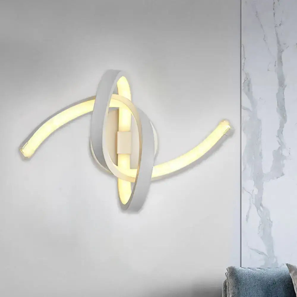 Modern white knotted linear wall sconce with sleek intertwined curved arms emitting warm yellow LED light
