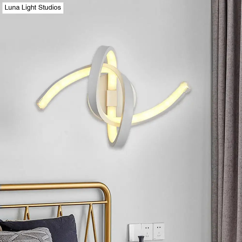 Modern white knotted linear wall sconce with sleek intertwined ring design and warm yellow LED illumination for bedroom use