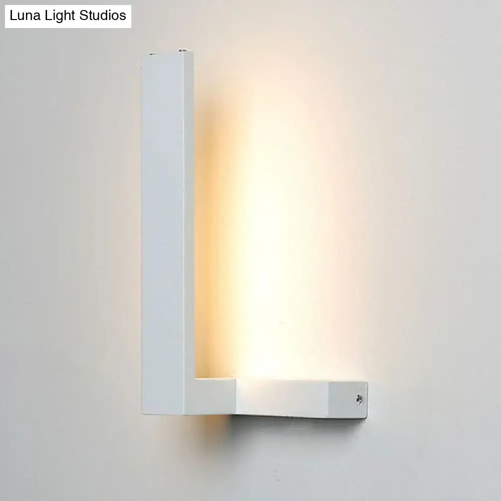 Minimalist modern white l-shaped led wall sconce with sleek geometric design emitting warm ambient light for living room