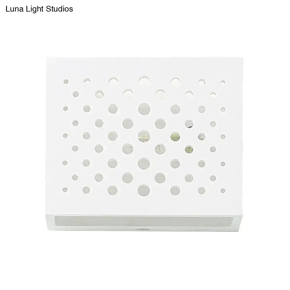 Modern white laser cut cube wall light with circular cutouts mounted on bedroom gypsum wall sconce