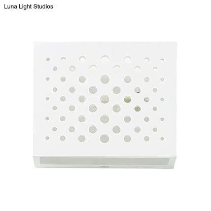 Modern white laser cut cube wall light with circular cutouts mounted on bedroom gypsum wall sconce