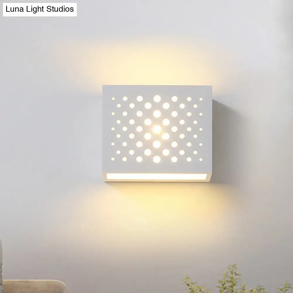 Modern white laser cut cube gypsum wall light with circular cutouts and warm diffused glow for bedroom use