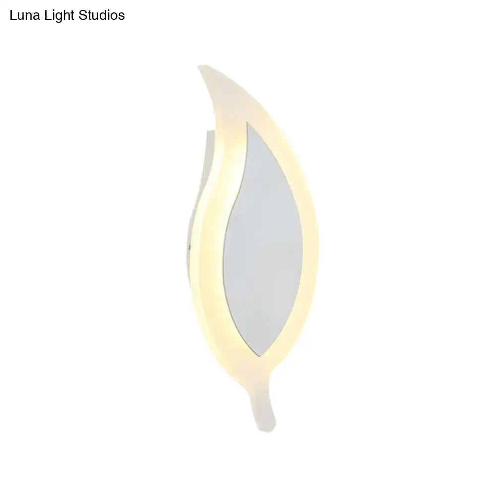 A modern white leaf wall lamp with a sleek design and warm led glow perfect as a bedroom wall sconce