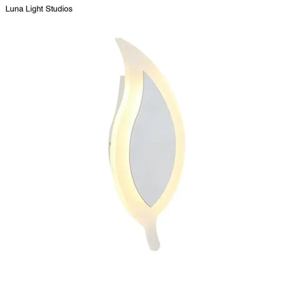 A modern white leaf wall lamp with a sleek design and warm led glow perfect as a bedroom wall sconce