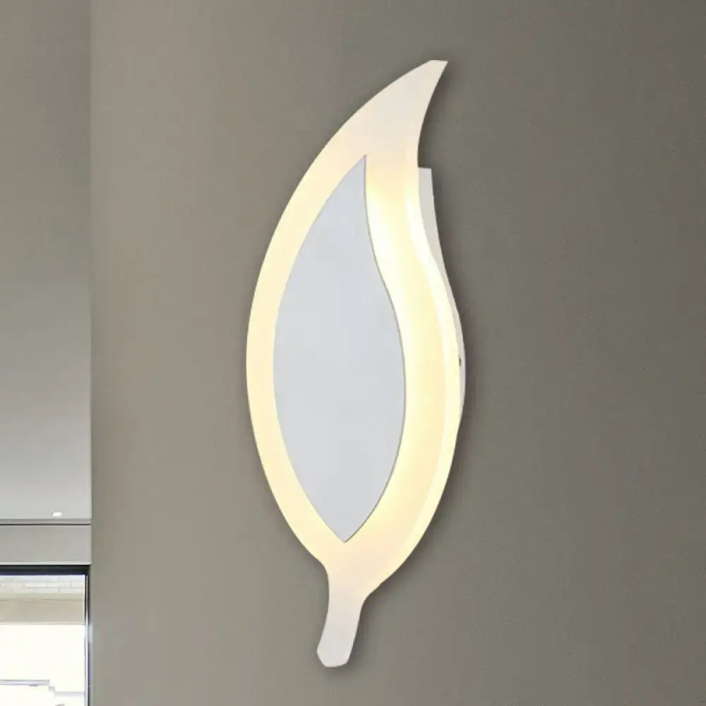Modern white leaf wall lamp with softly glowing led light frame designed as a sleek wide leaf wall sconce