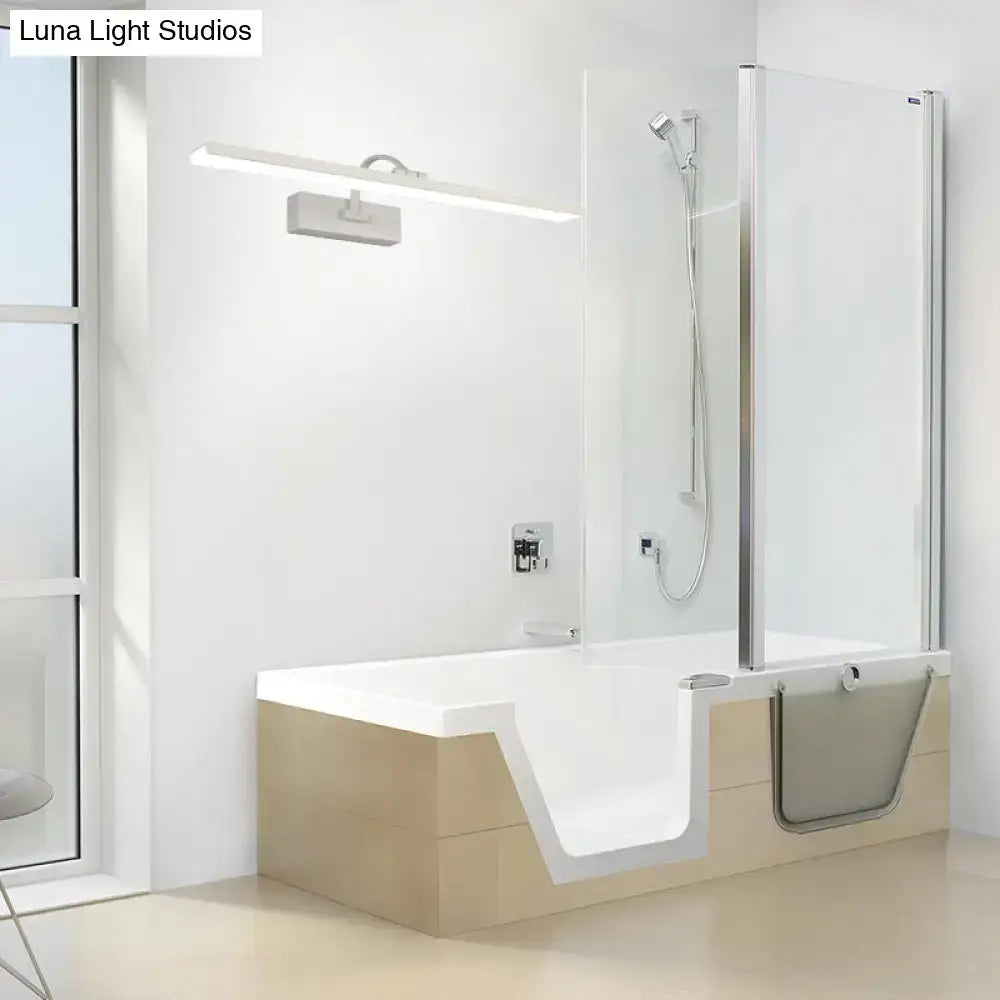 Modern white led bathroom vanity sconce with curved arm installed above a white bathtub with beige wooden base and fold-down step