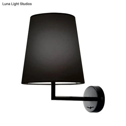 Modern white led cone wall mounted fabric sconce featuring a black drum-shaped lampshade and matte black circular base