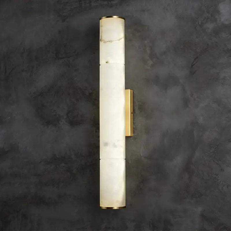 A sleek modern wall lamp with white marble body and gold-toned brass accents designed as a living room sconce fixture