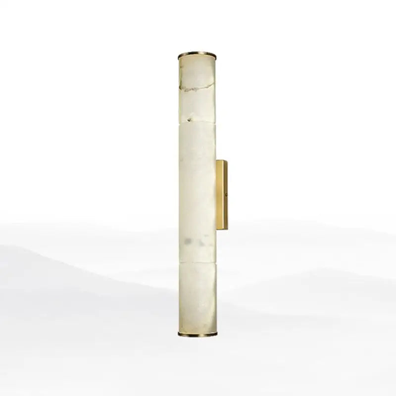 Modern white marble and brass wall lamp with a tall cylindrical fixture height designed as a living room sconce