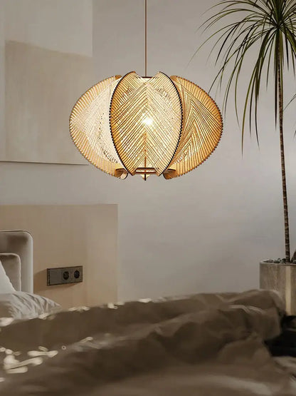 Modern white marble dining table with wood base paired with warm-toned handmade rattan pendant light decorbites design