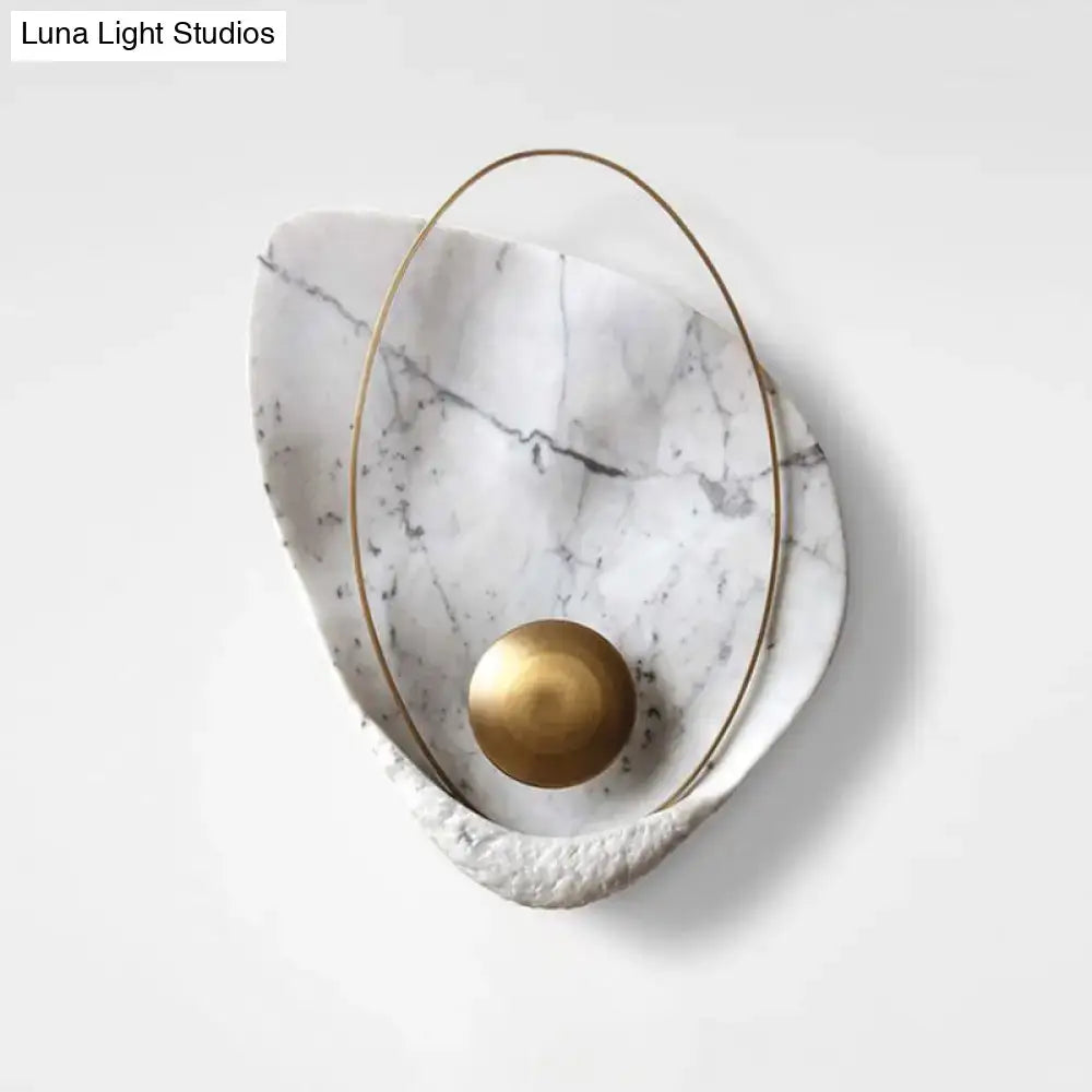 Modern white marble and gold wall lamp with teardrop design featuring polished brass sphere and fixture height suitable for living room