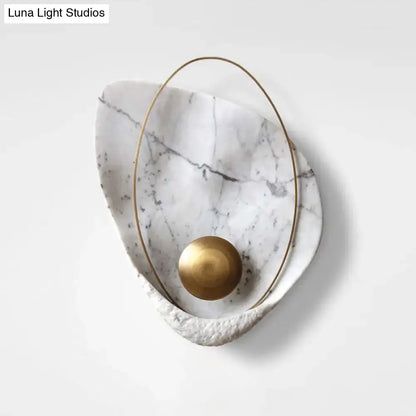 Modern white marble and gold wall lamp with teardrop design featuring polished brass sphere and fixture height suitable for living room