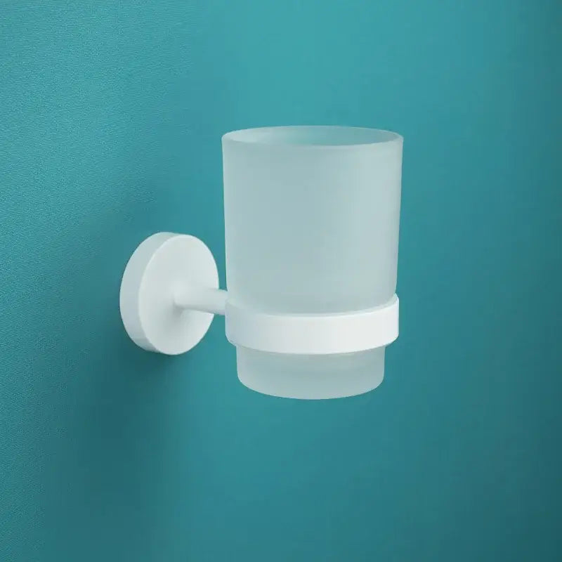 Modern white matte metal bathroom accessory set featuring a white frosted glass toothbrush holder with wall-mounted base decorbites bathroom accessory