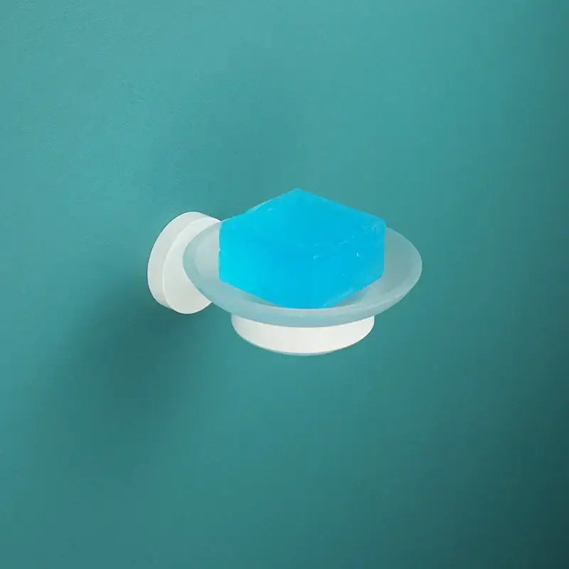 White plastic wall-mounted soap dish with translucent blue soap from decorbites bathroom accessory set for modern bathrooms