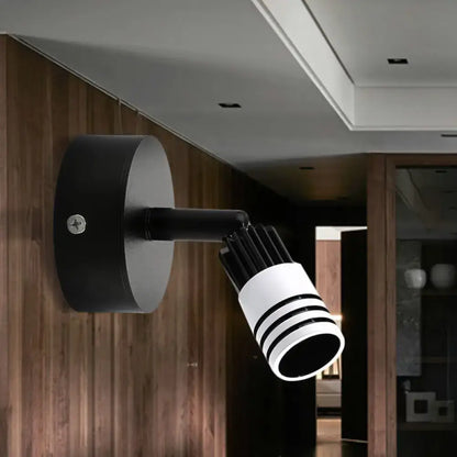 Modern white metal wall mounted led spotlight with black and white cylindrical design and horizontal striped lens