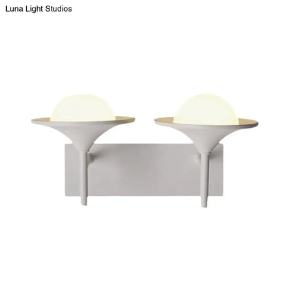 Modern white metallic flared wall sconce with dual sleek matte white heads and warm frosted dome LED light for bedroom use