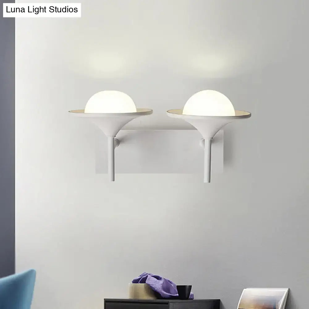 Modern white metallic flared wall sconce with sleek minimalist design and frosted glass domes for bedroom LED lighting
